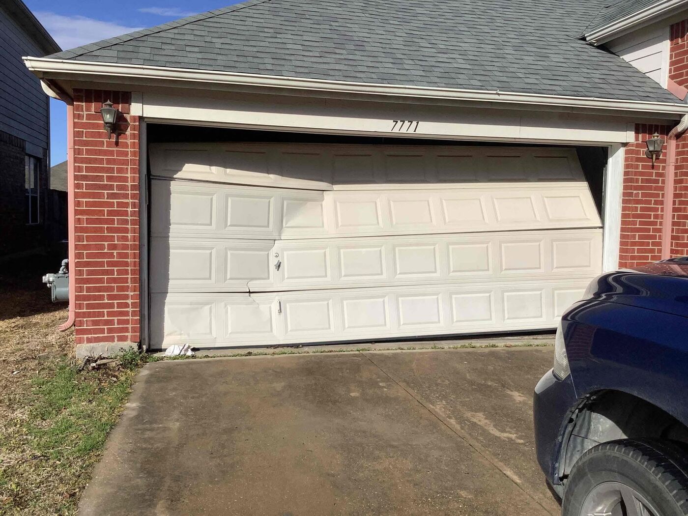 Cracked garage door panel section on a residential home