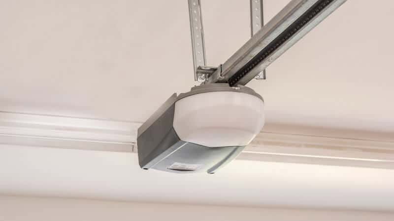 Newly installed belt-drive garage door opener on ceiling rail
